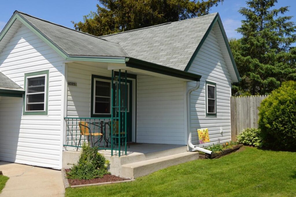 cropped home with gray trim and stoop