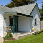 cropped home with gray trim and stoop